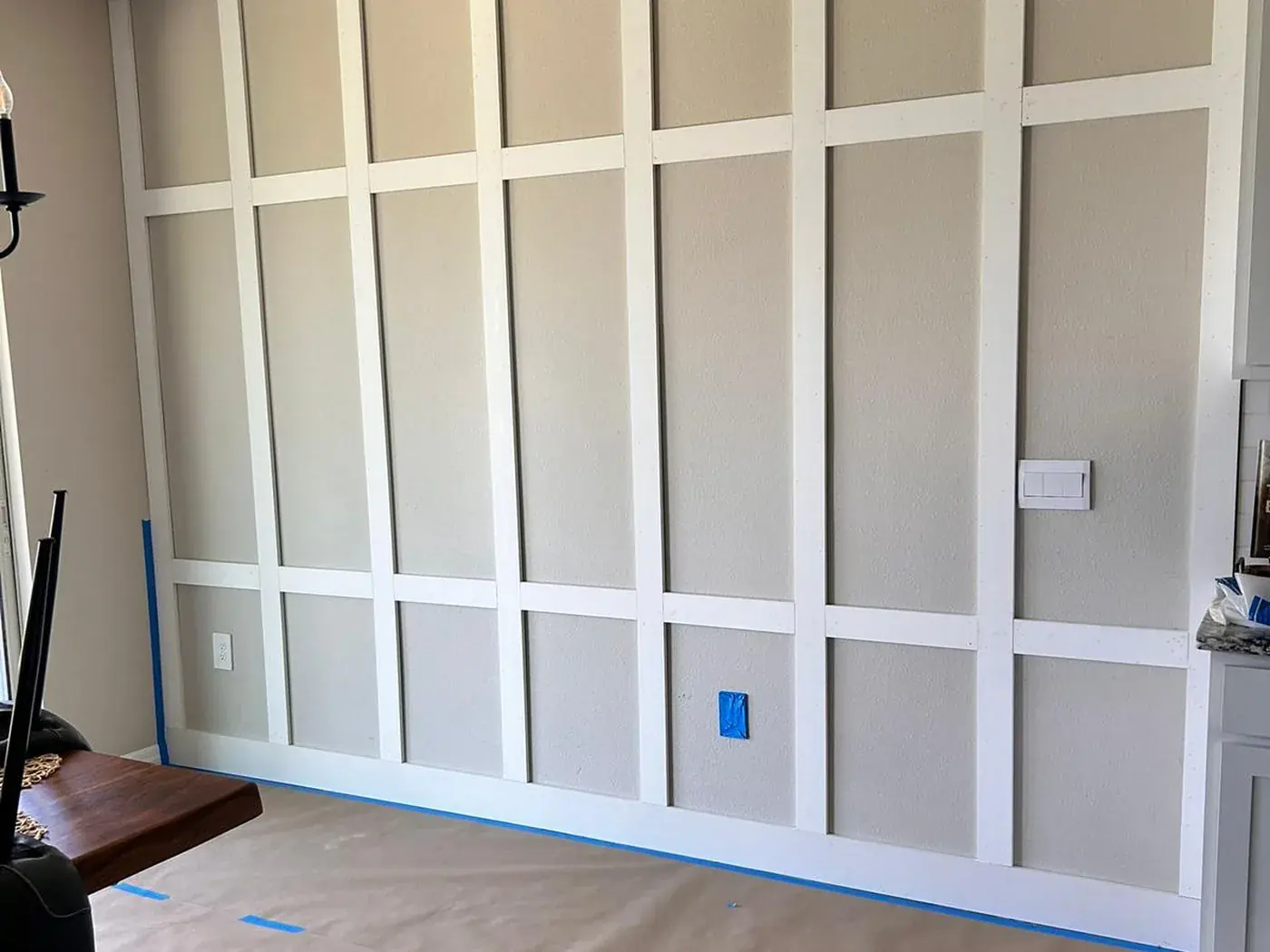 Full height panel grid set out on a dining room wall before painting