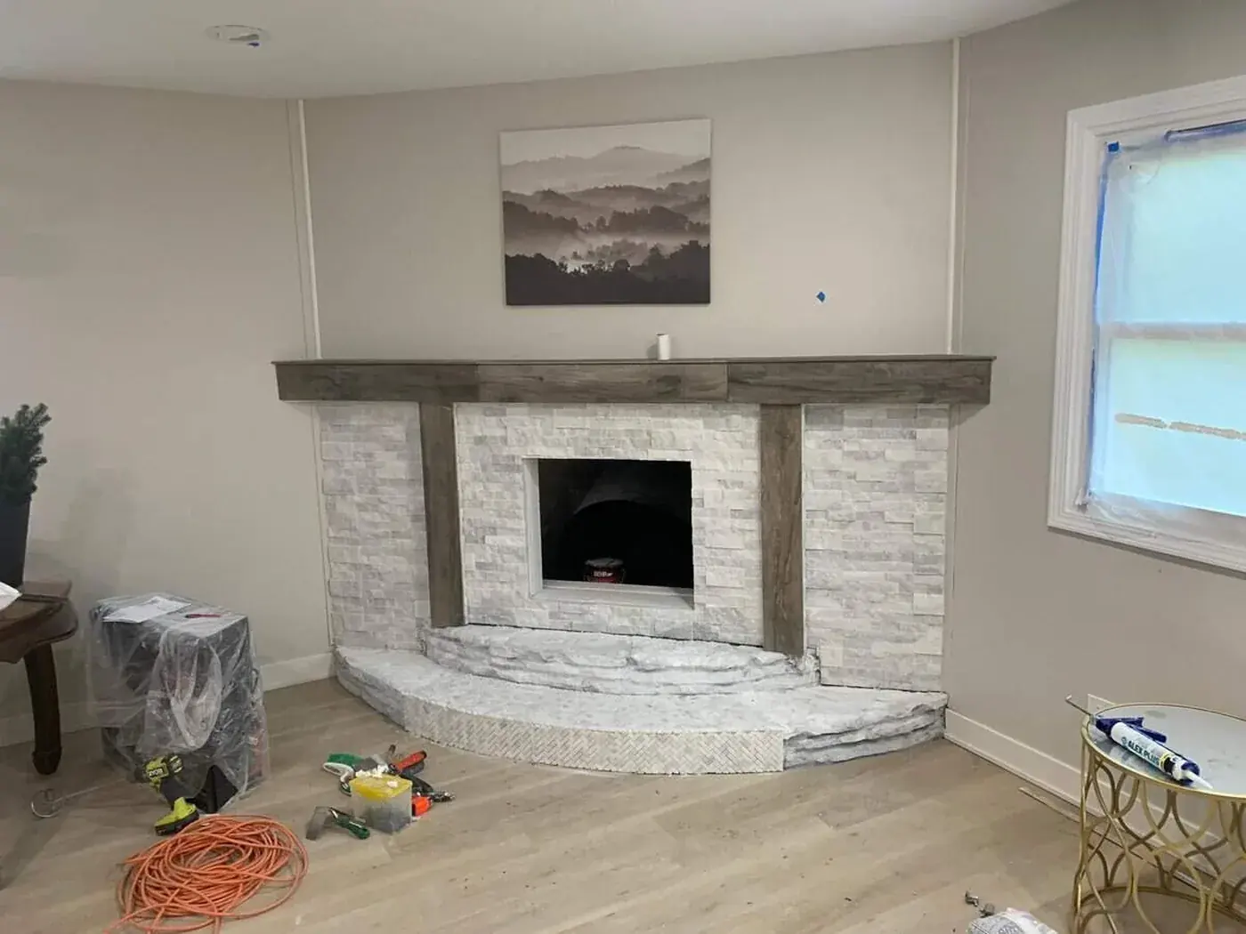 The finished fireplace with its stone surround and timber mantel in place