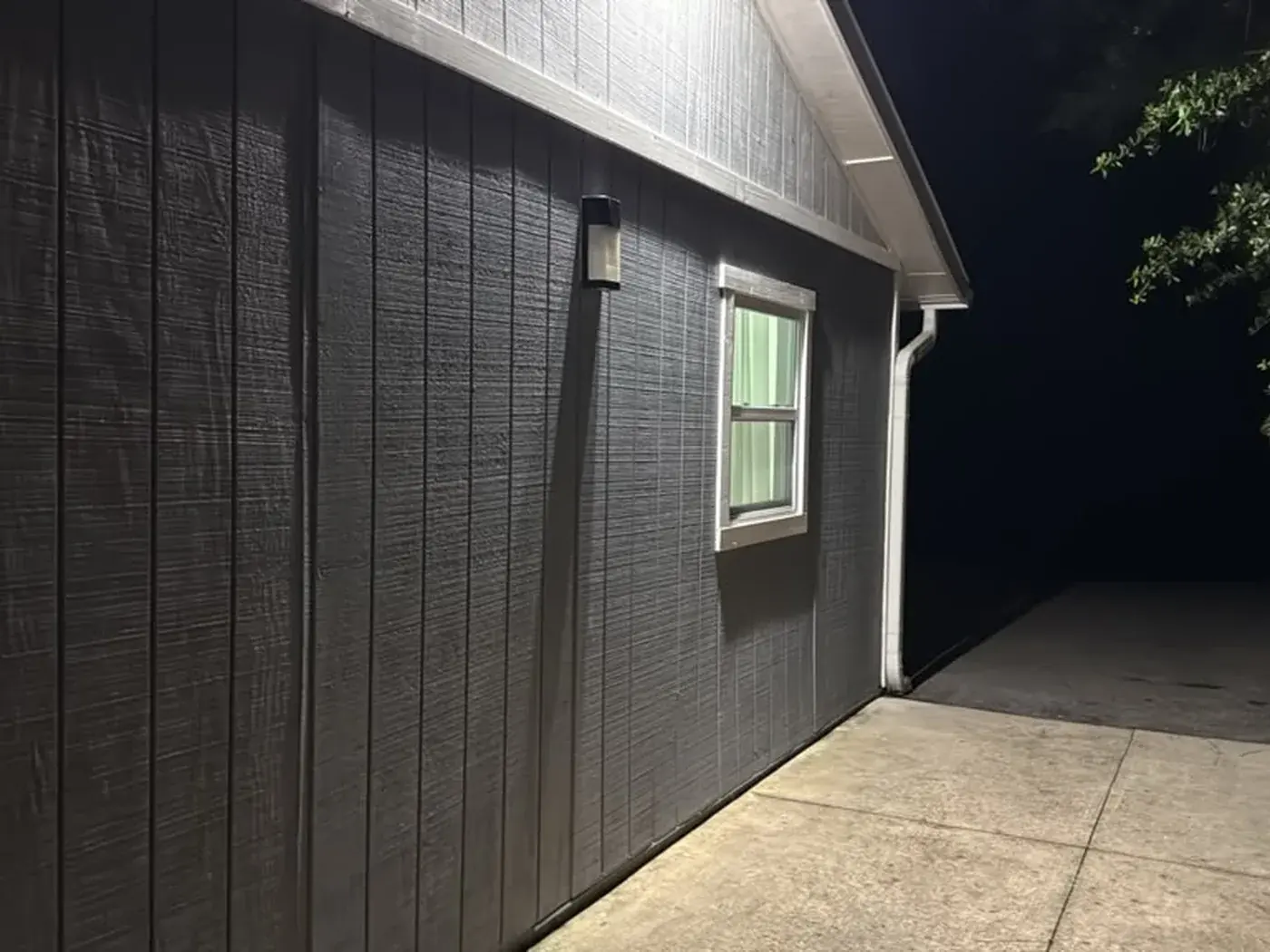 The same wall after repainting in deep charcoal with the white trim kept