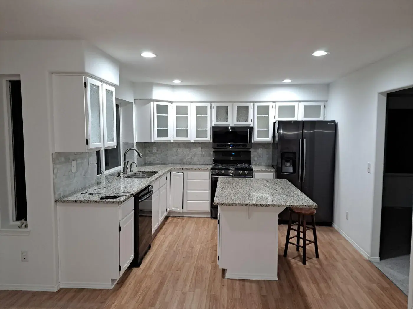Kitchen after cabinet refinishing, cabinets and island sprayed white