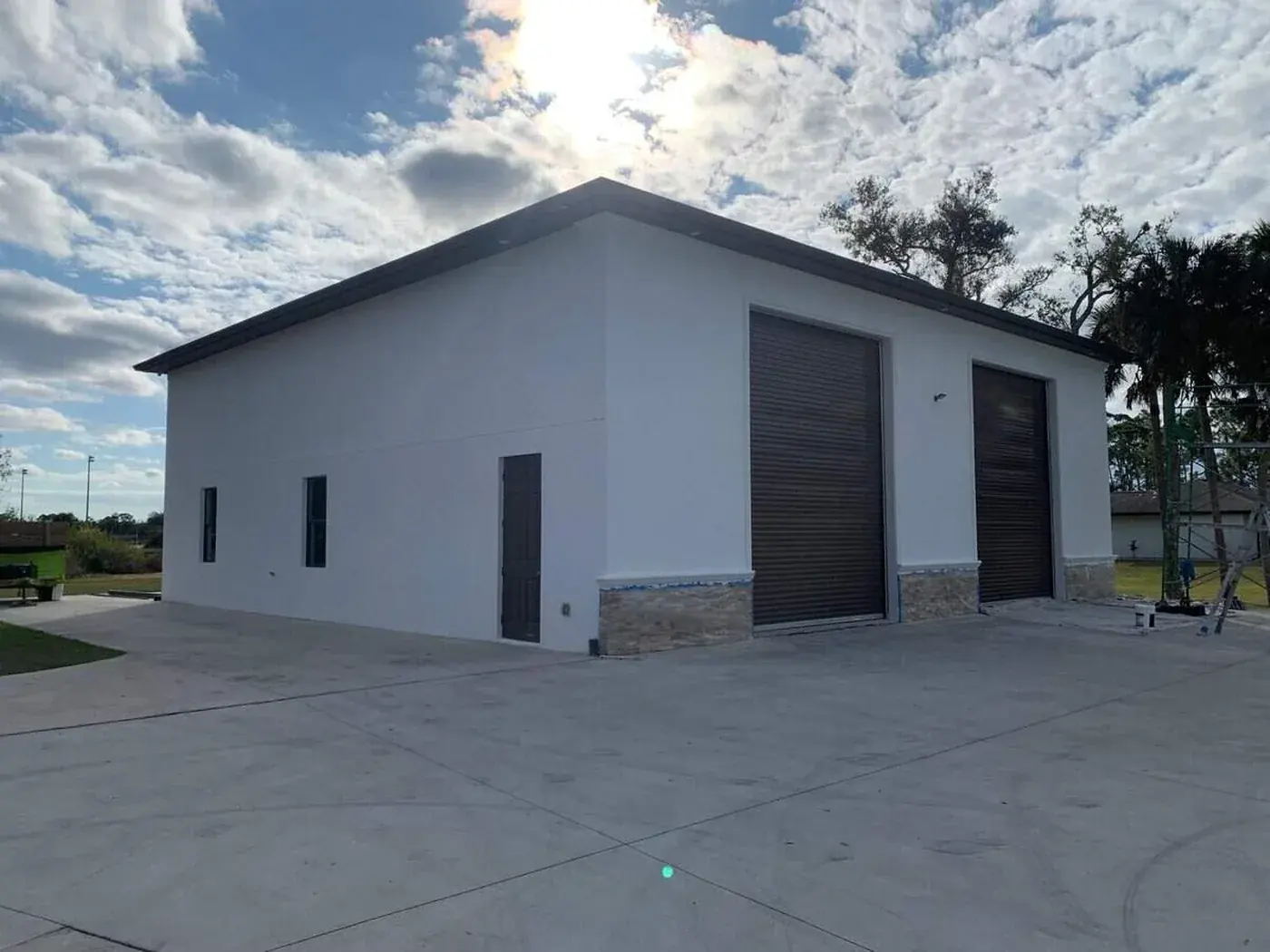 Commercial building with two roll up doors, walls and trim freshly painted