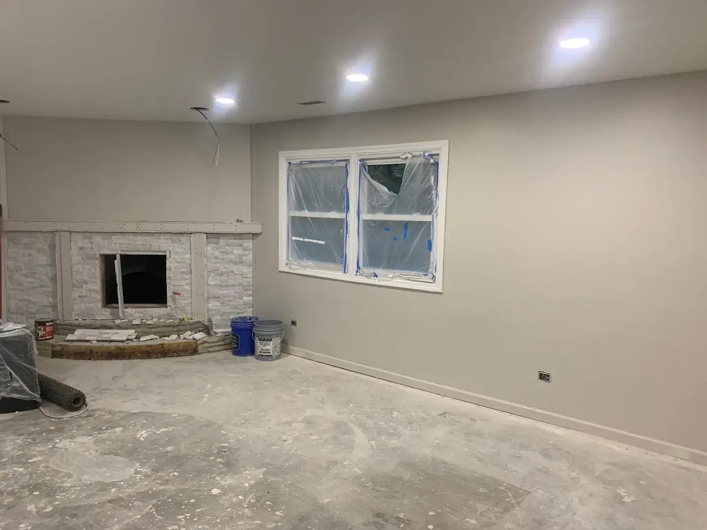 Living room walls patched, textured and repainted before the floor goes in