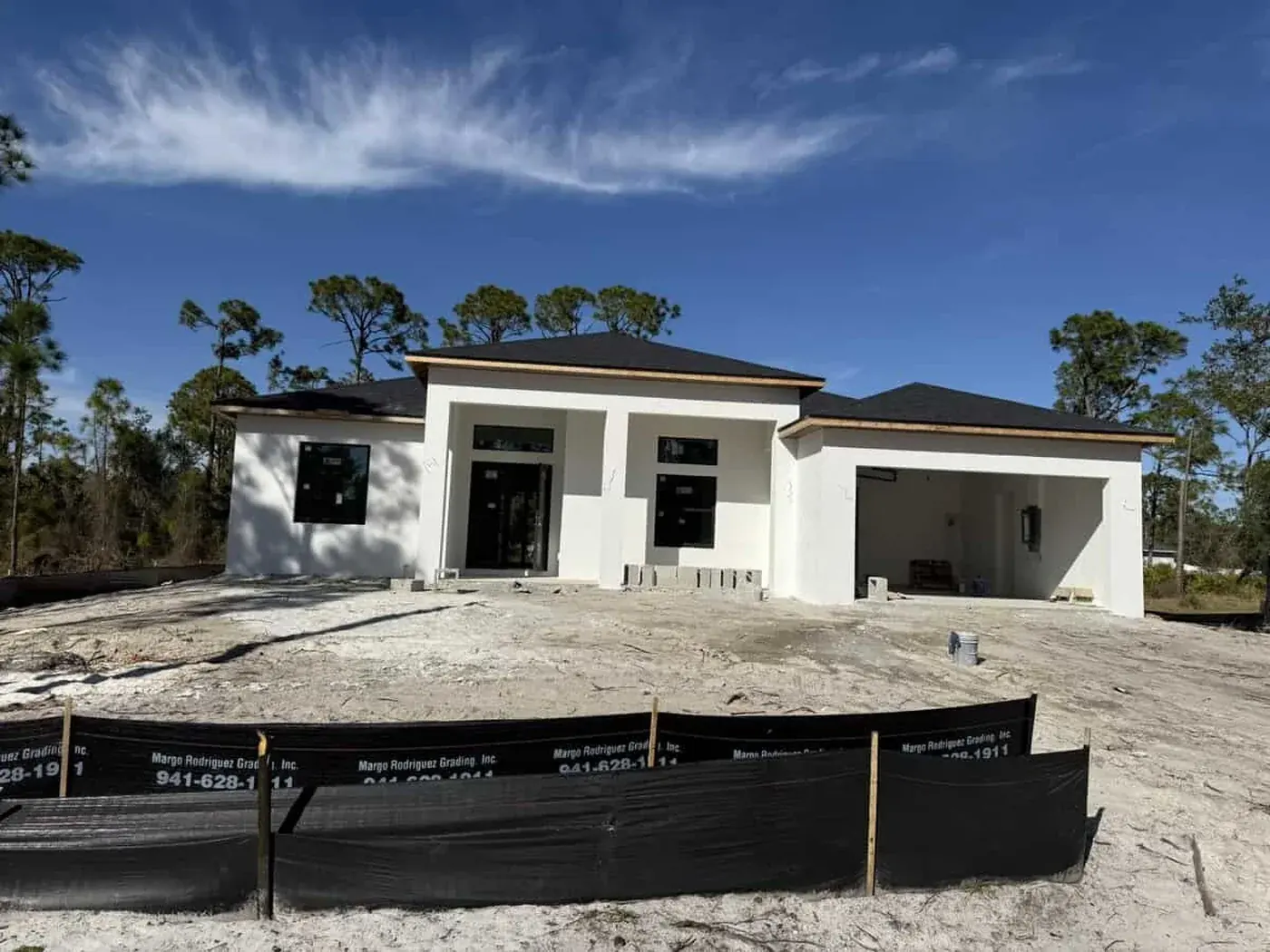 New build with the exterior stucco coated, site fence still up