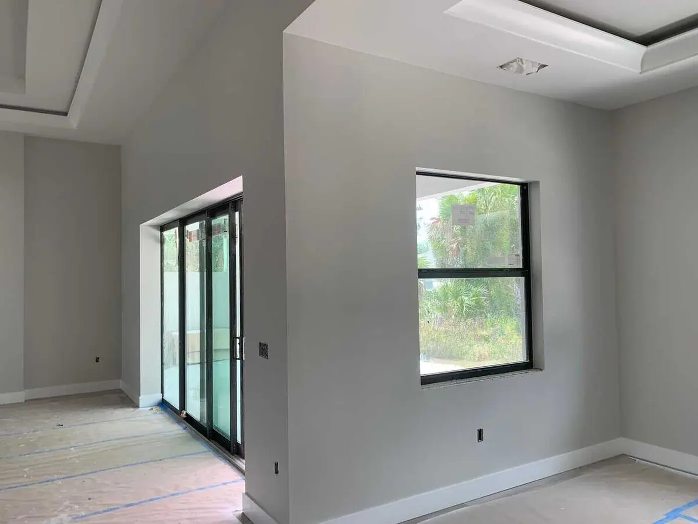 Interior repainted in soft grey with black framed sliders onto the lanai