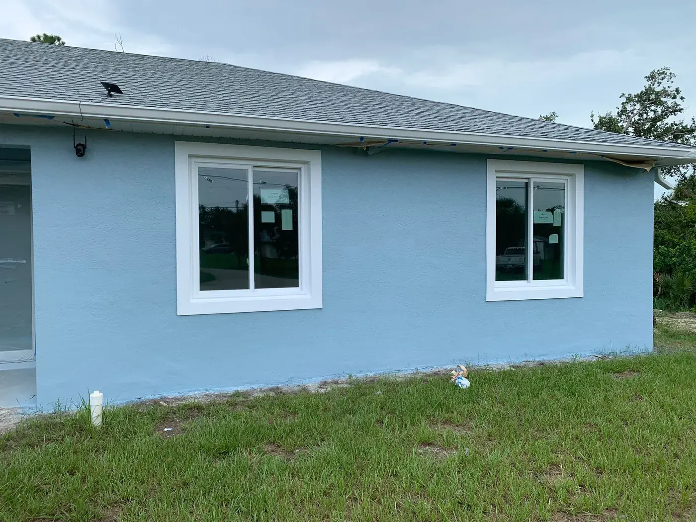 Single storey Florida home repainted light blue with white trim in North Port