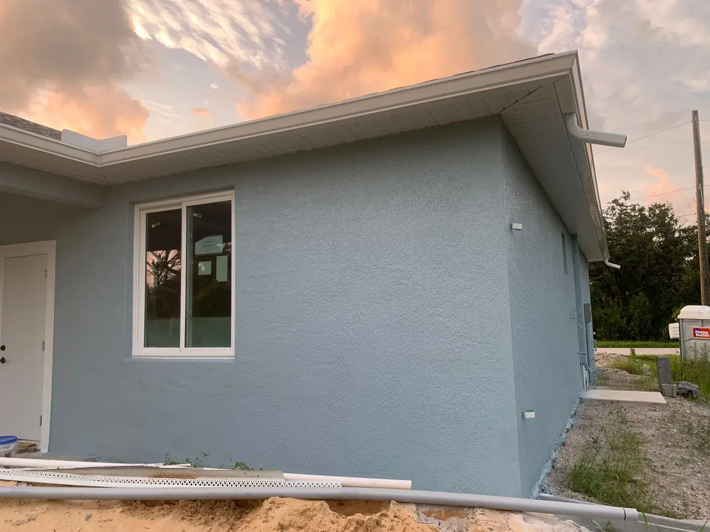Grey stucco home repainted in Port Charlotte