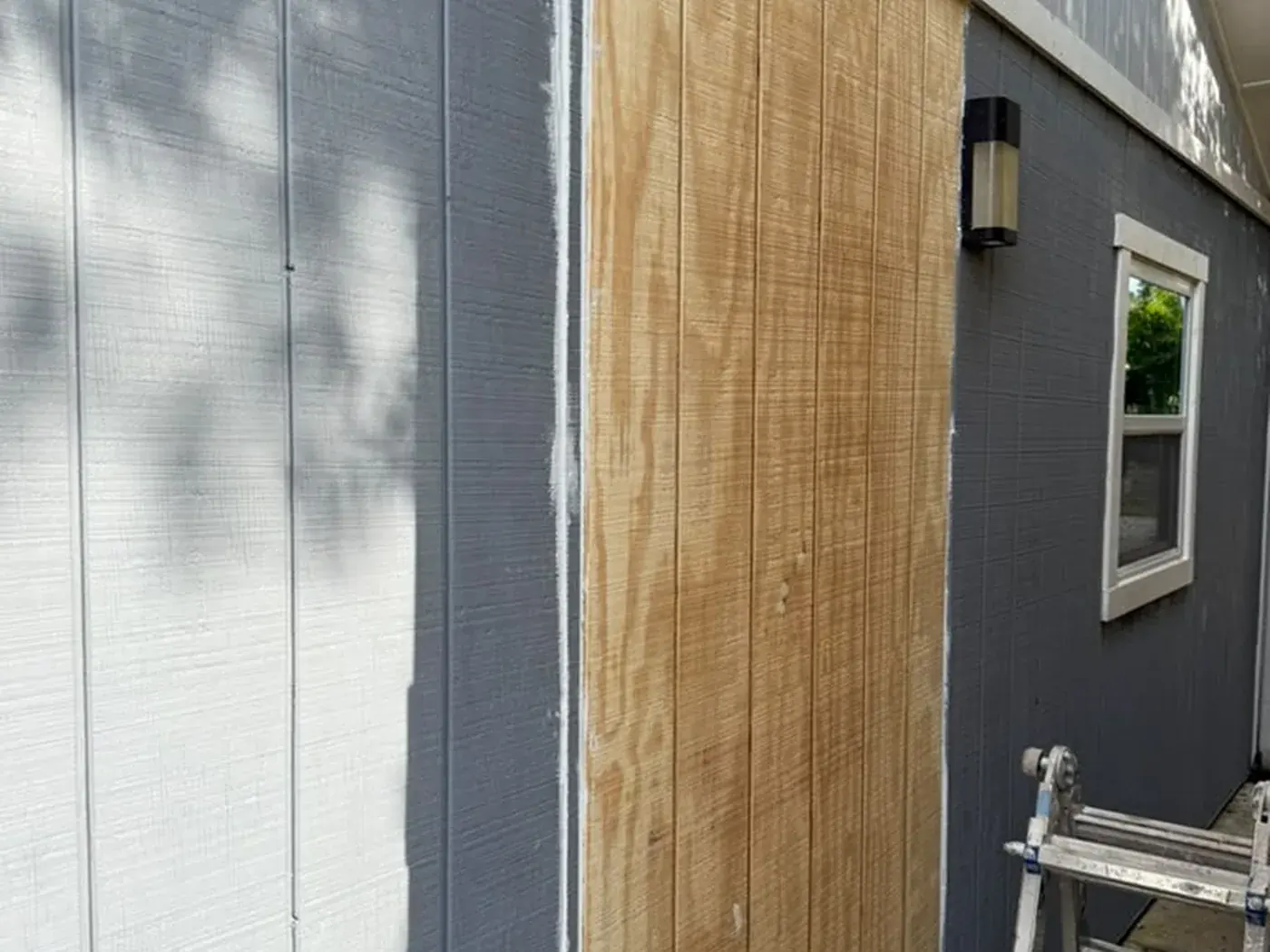 The same Sarasota wall part way through, one siding panel replaced and primed
