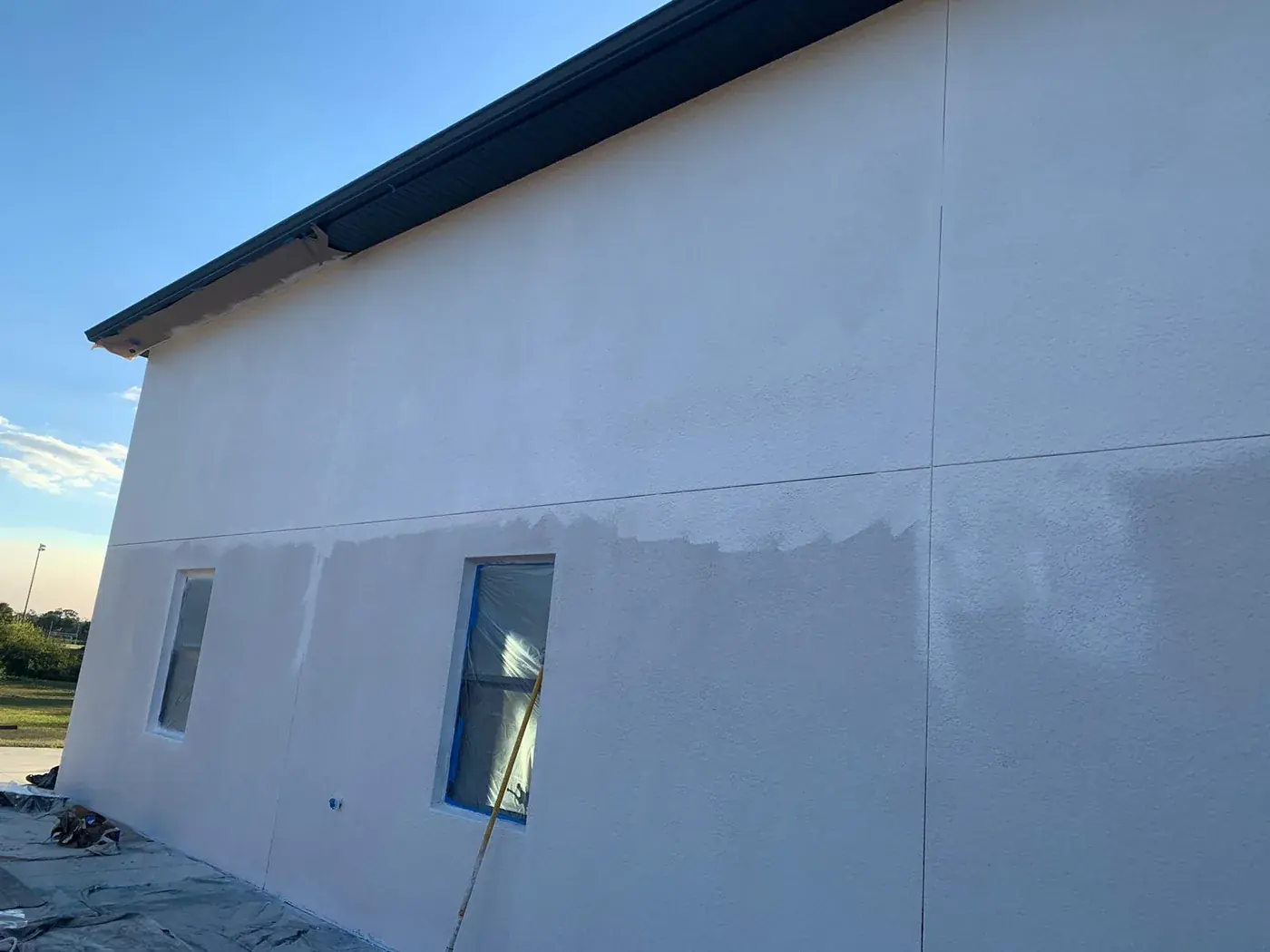 Stucco wall showing the difference between the first and second coat
