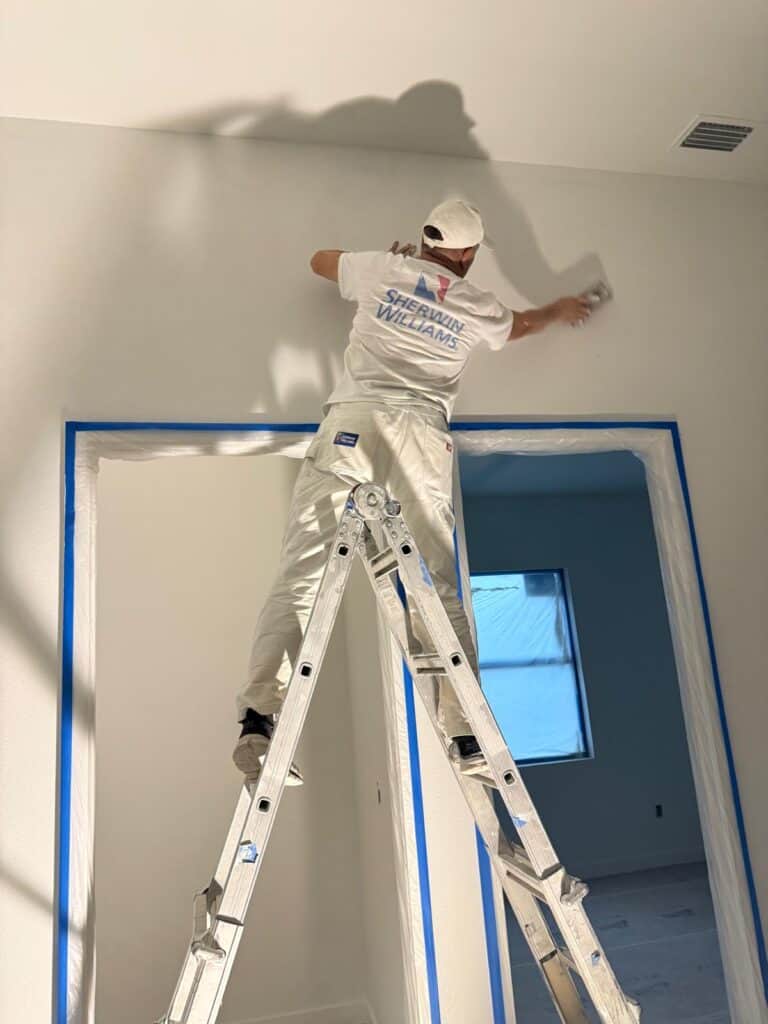 Professional painter in South Florida working on interior wall preparation